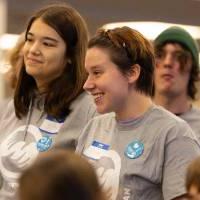 Two students smiling while wearing gray "Make a Difference Day" shirts